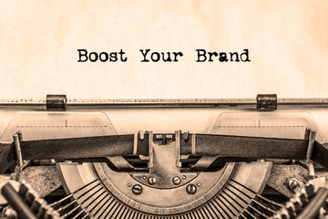 Boost your Brand printed on a piece of paper on a vintage typewriter. writer.