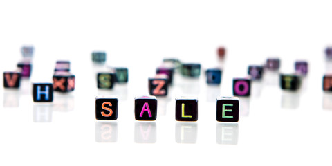 Black Cubes Or Blocks With Colorful Bright Letters On White Background. Word From Colorful Cubes Or Dice - Sale. Concept Sale.