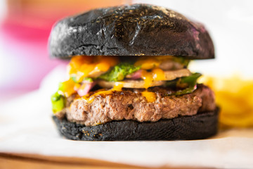 Big Black Tasty Sandwich - Hamburger Or American Burger With Beef, Pickles, Tomato And Sauce On Table. Concept Fast And Unhealthy Food, Unhealthy Eating.