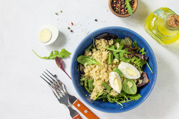 Diet menu, Vegan food. Healthy salad with quinoa, arugula, green Beans and Eggs on a white stone table. Top view flat lay background. Copy space.