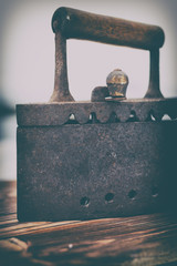 Ancient iron iron for ironing coals. Iron. on wooden background