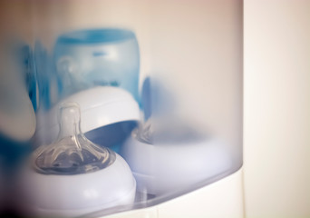teats and baby bottles inside a steam sterilizer
