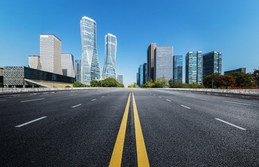 Naklejka premium Empty road floor surface with modern city landmark buildings of hangzhou bund Skyline,zhejiang,china