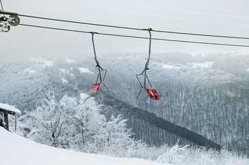 Naklejka premium Ski lift ski resort. Winter fun. Family holidays and travel in the mountains. Nature forest landscape
