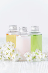 Fototapeta na wymiar natural cosmetic bottles with fresh flowers, toiletries, hygiene products