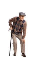 Senior man with a knee pain walking with a cane