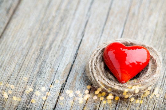 Two red heart-shaped on a wooden background.