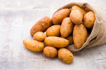 A bio russet potato wooden vintage background.