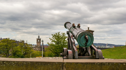 Closeup of The Portuguese Cannon on Calton Hill in Edinburgh, Scotland, pointing towards a distant tower clock.