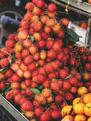 Rambutan or red hairy lychee on the market in Vietnam - obrazy, fototapety, plakaty