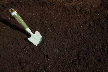 Garden trowel in substratum for orchard
