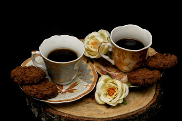 cup of coffee and cookies on table