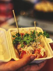 Fresh deep fried asian street food: Tokoyaki served on a night market