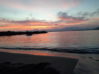 An amazing caption of small waves and beautiful sunset with an incredible reflection over the sea and some coloured clouds in winter days