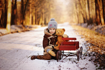 Child in winter. Fun little boy in the snow. The child is playing outside. Winter background....