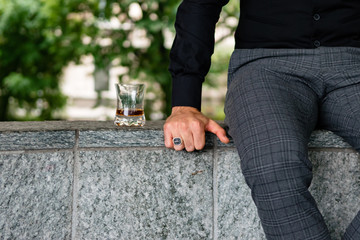 Fototapeta premium Man drinking a whiskey in Milan