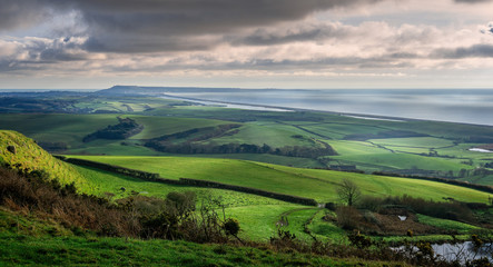 Panoramic view of Portand and Chesil Beach from the hill tops near Abbotsbury in Dorset, UK - obrazy, fototapety, plakaty