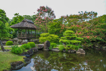 Japanese Garden with lake and a hut near Kyoto, Japan