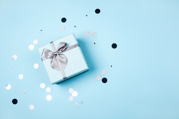Blue present box on trendy pastel background.