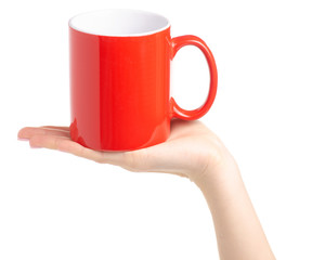 Red cup mug in female hand on white background isolation