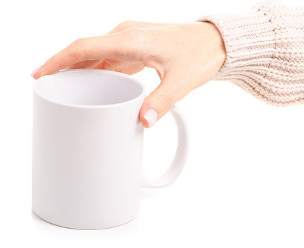 White cup mug in female hand on white background isolation