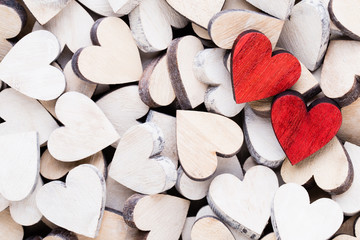 Obraz premium Valentines day background with white end red hearts on wooden background.