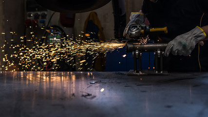 worker at work with his grinder in a metalworking industry