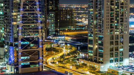 Fototapeta premium Buildings of Jumeirah Lakes Towers with traffic on the road night timelapse.