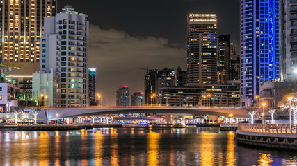 Obraz na płótnie Canvas View of Dubai Marina Towers and canal in Dubai night timelapse