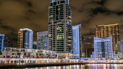 View of Dubai Marina Towers and canal in Dubai night timelapse