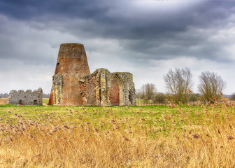 UK, NORFOLK - MARCH 2018: St Benet's Abbey gatehouse and mill on the Norfolk Broads during a winter storm.