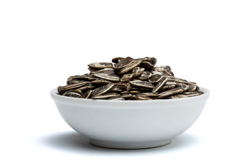 white bowl with sunflower seeds with peel