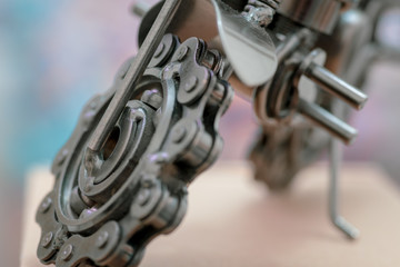 Close up (Macro) of Handmade metal toy motorcycle/motorbike made out of scrap metal pieces with short depth of view
