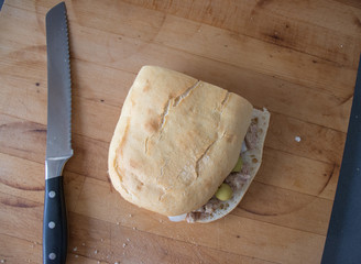 Sandwich with tuna, olives and small onions in vinegar