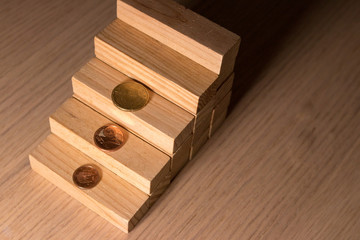 Coins and pieces of wood as a concept of saving and economic expense