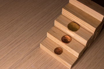 Coins and pieces of wood as a concept of saving and economic expense