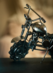 Close up (Macro) of Handmade metal toy motorcycle/motorbike made out of scrap metal pieces with short depth of view