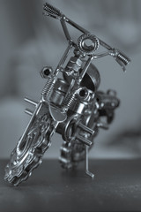 Close up (Macro) of Handmade metal toy motorcycle/motorbike made out of scrap metal pieces with...