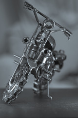 Close up (Macro) of Handmade metal toy motorcycle/motorbike made out of scrap metal pieces with short depth of view