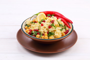 Vegetarian dish of couscous and vegetables with pomegranate and chickpeas