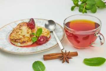 Cheesecakes on a saucer with jam and tea. cottage cheese pancake