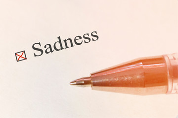 Sadness - check box with a cross on white paper, concept