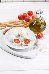 Mozzarella with cherry tomatoes and grissini sticks