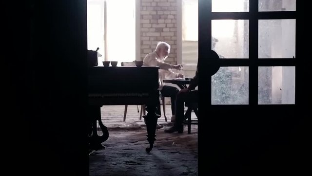 Soldier of the Russian army interrogates a suspect, an elderly man with a beard, under pain of execution, signs papers, the injustice of the NKVD, cynicism of the soldiers, the cruelty of the USSR