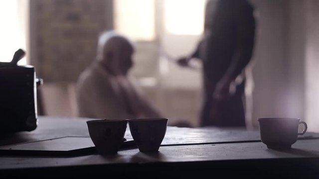 Soldier of the Russian army interrogates a suspect, an elderly man with a beard, under pain of execution, signs papers, the injustice of the NKVD, cynicism of the soldiers, the cruelty of the USSR
