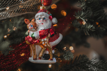 glass Santa Claus ornament on a Christmas tree © Jordan