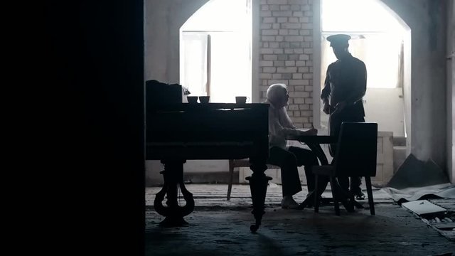 Soldier of the Russian army interrogates a suspect, an elderly man with a beard, under pain of execution, signs papers, the injustice of the NKVD, cynicism of the soldiers, the cruelty of the USSR