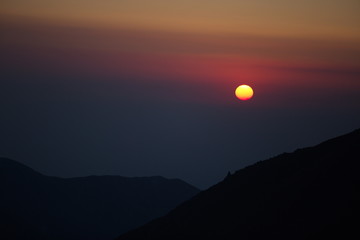 Majestic sunset in the mountains landscape with sunny beams. Dramatic scene. Carpathian, Ukraine, Europe. Beauty world. Retro style, vintage filter. Instagram toning effect.
