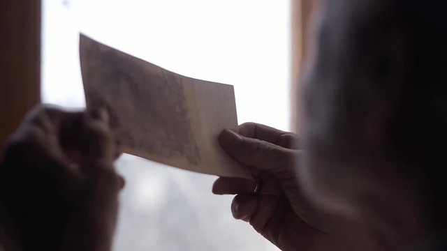 A rich old man in his castle considers old money, old times of the beginning of the 20th century, a wealthy, bearded man inside an old gloomy house, a cinematic picture, a mysterious castle of writer