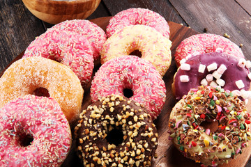 assorted donuts with chocolate frosted, pink glazed and sprinkles donuts